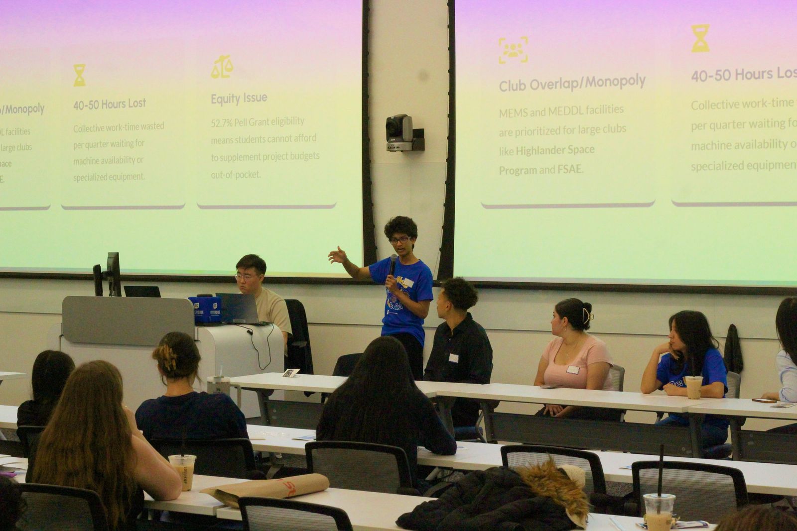 Naman presenting the manufacturing-space proposal on stage at UCR's Re:Write, Re:Build Symposium